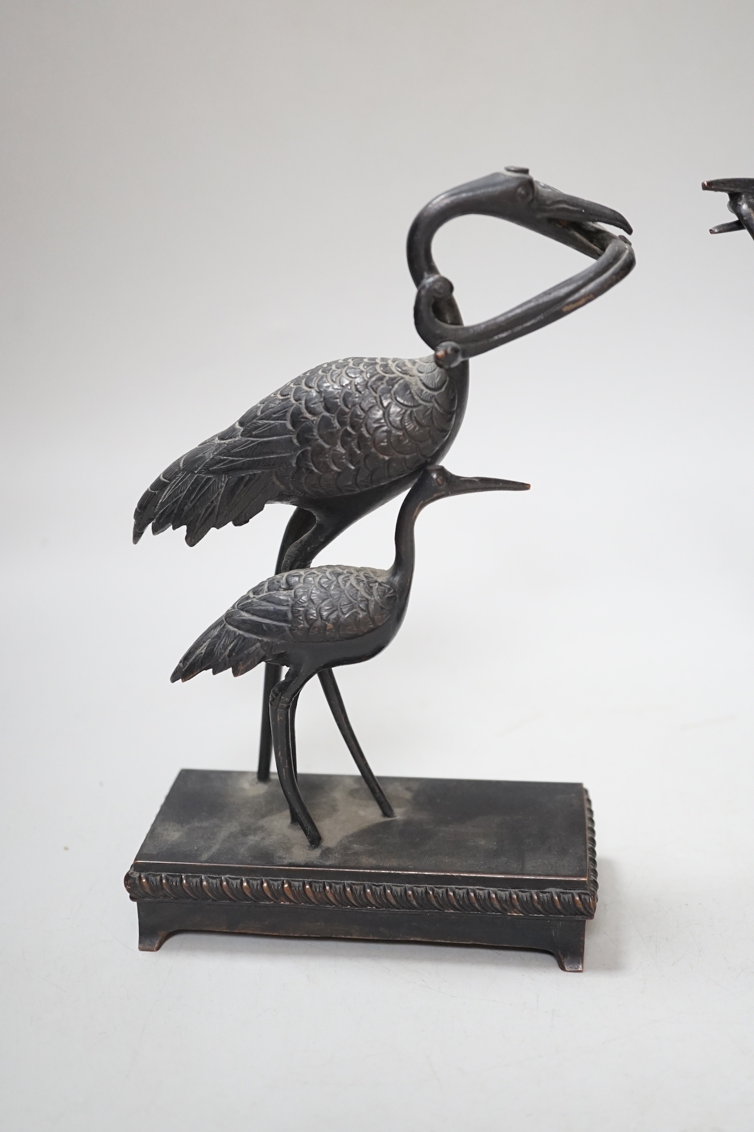 A pair of Japanese bronze crane figure groups, on later bases, 18cm high